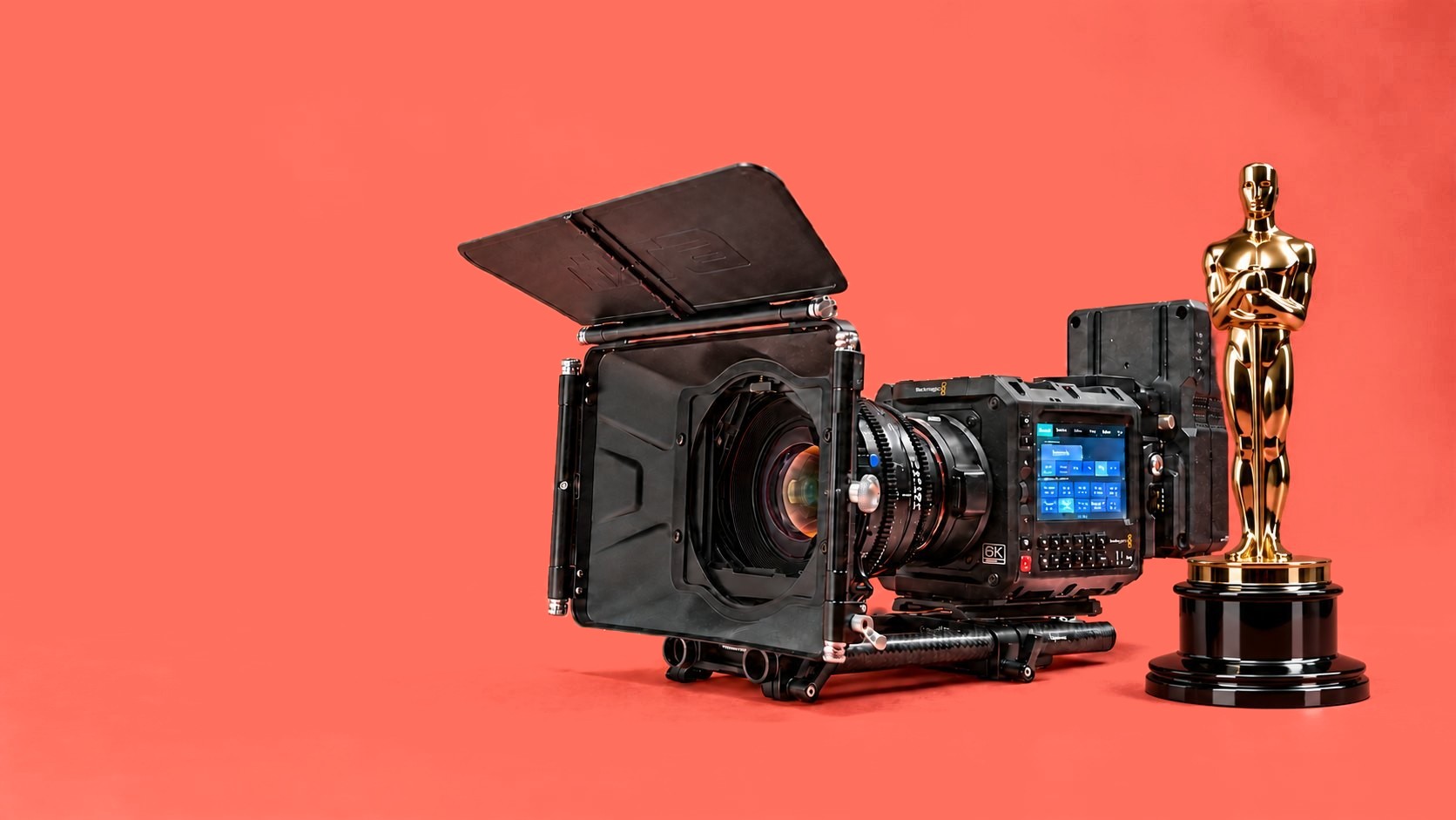 Cinema camera beside an award statuette