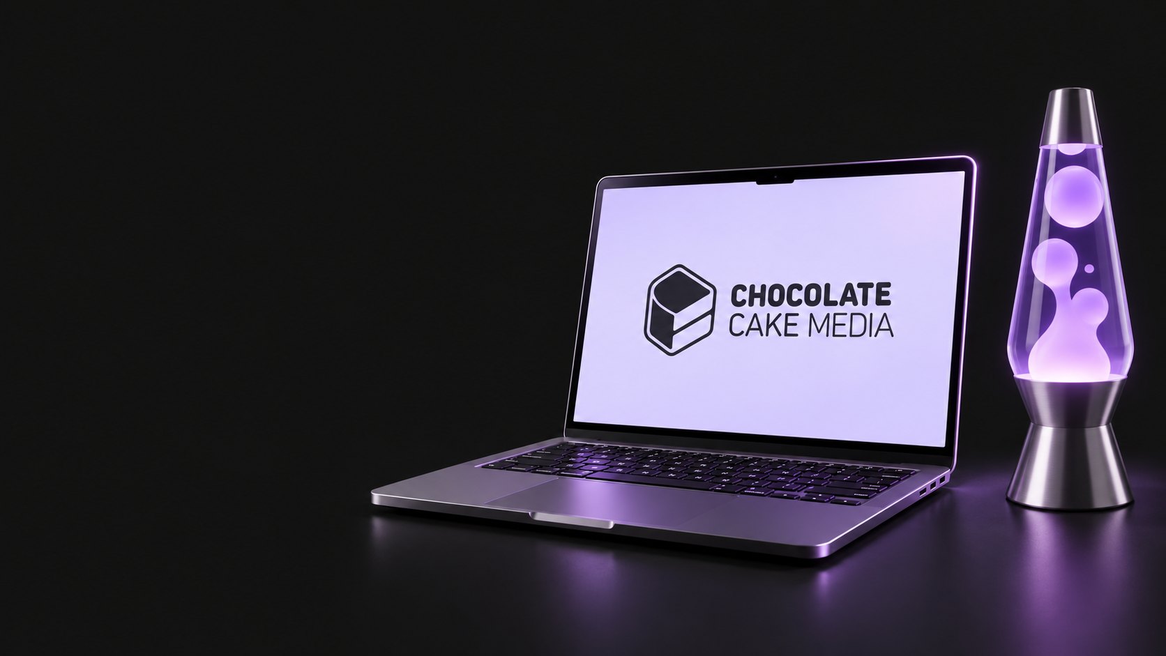 Laptop with the CCM logo beside a lava lamp